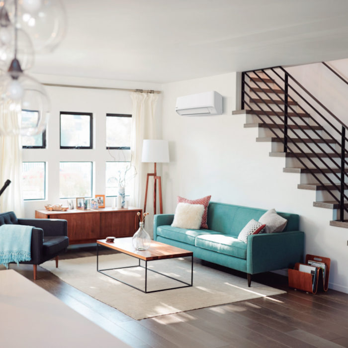 Panasonic Klimaanlagen - Helles Wohnzimmer mit türkiser Couch unter Treppenaufgang